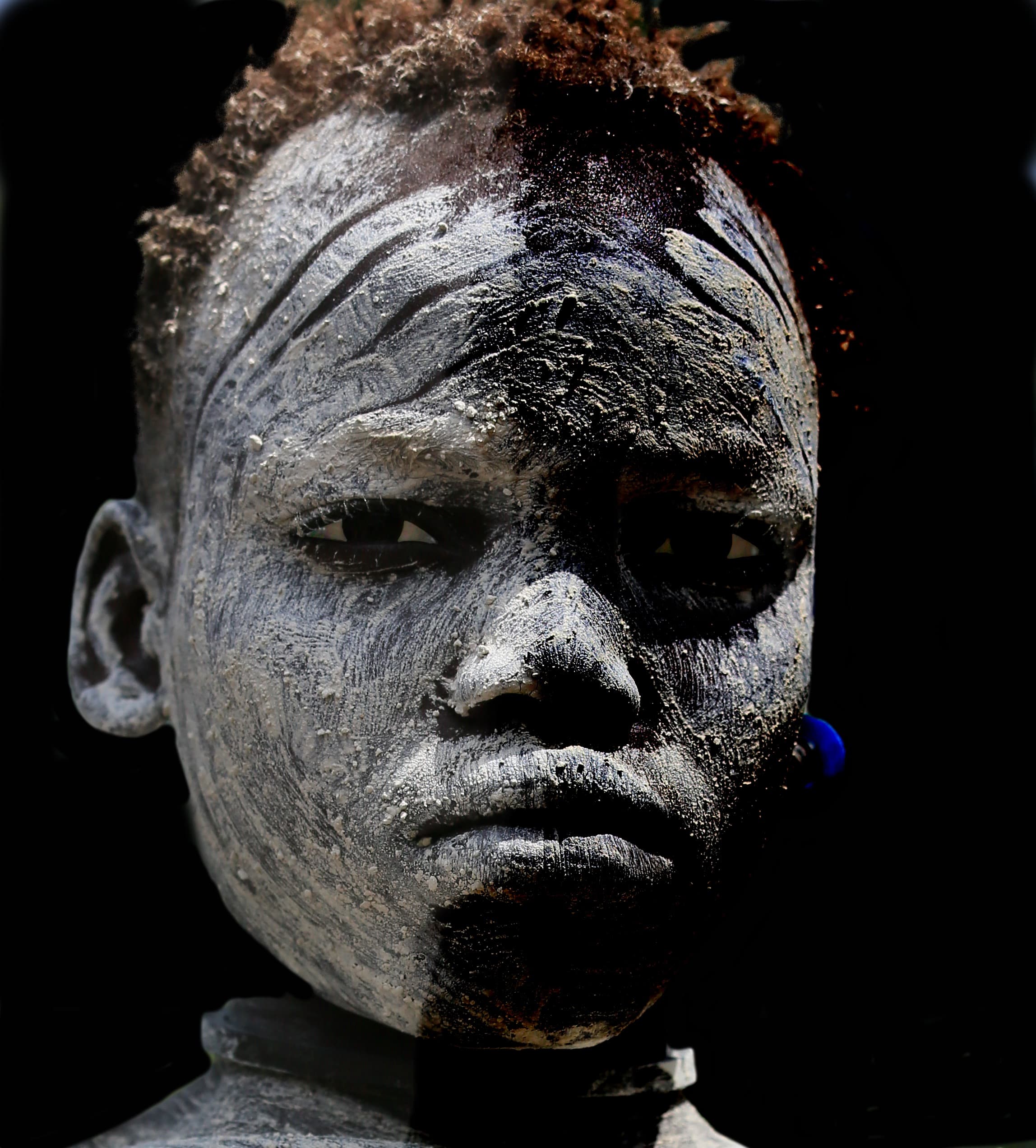 Suri child with white face paint in southwestern Ethiopia