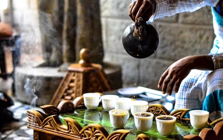 Traditional Ethiopian coffee ceremony with roasting and jebena brewing