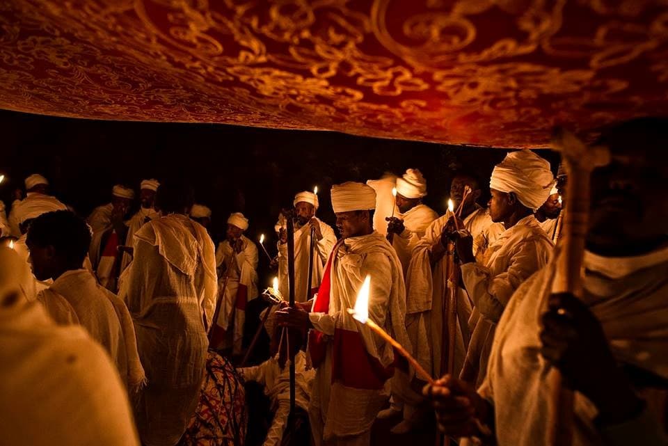 Priests holding candles during Genna night vigil in Lalibela